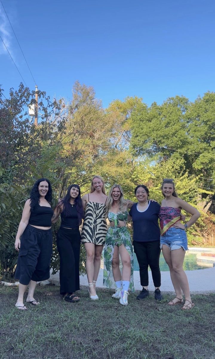 Retreat women smiling together in the backyard by the pool