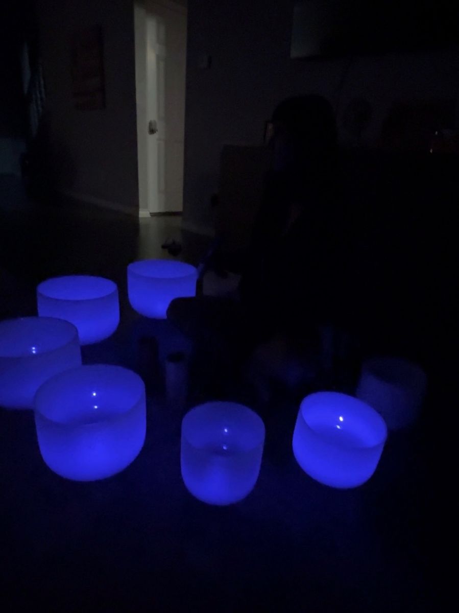 Glowing crystal singing bowls set up for a sound healing session