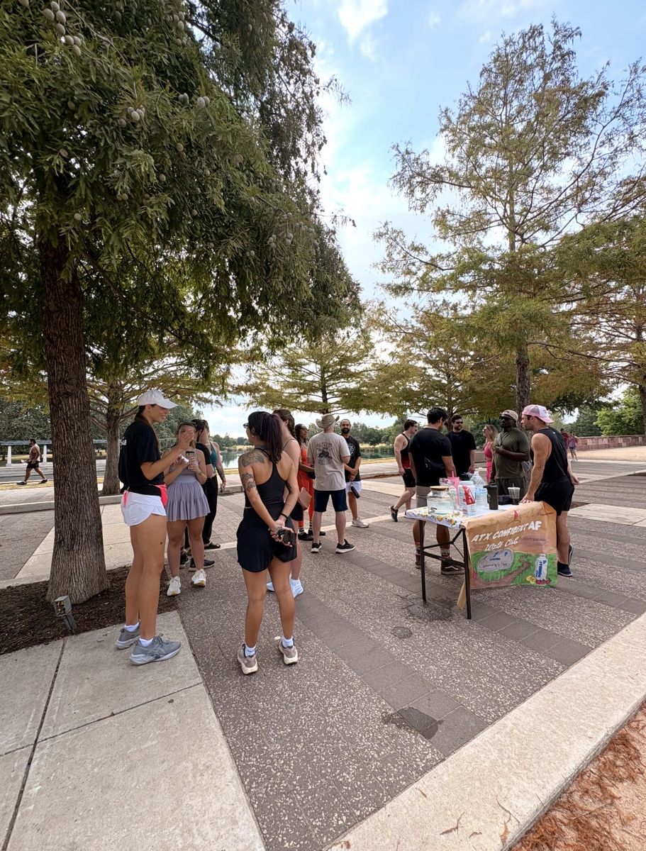 Walkers gathering around the walk table under the trees